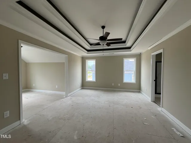 a view of a livingroom with a ceiling fan and window