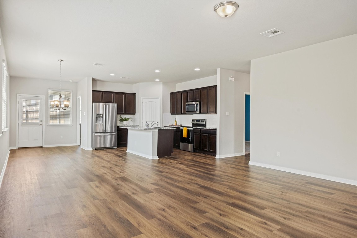 110 Lullaby Drive Georgetown, TX 78626 - Photo 12 of 39 a view of a kitchen with a sink and a refrigerator