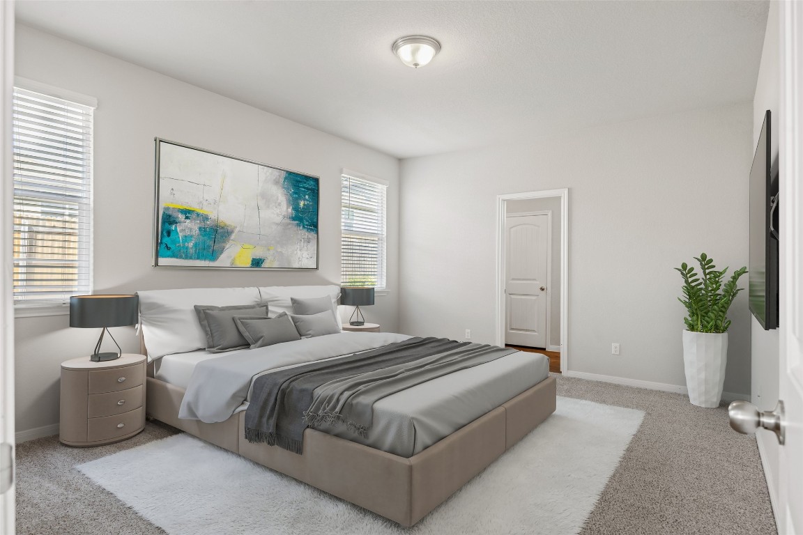 110 Lullaby Drive Georgetown, TX 78626 - Photo 14 of 39 a bedroom with a bed and a painting on the wall