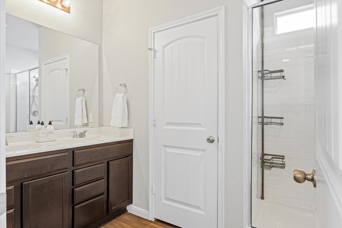 110 Lullaby Drive Georgetown, TX 78626 - Photo 17 of 39 a bathroom with a double vanity sink and mirror