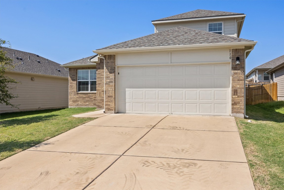 110 Lullaby Drive Georgetown, TX 78626 - Photo 2 of 39 a front view of a house with a yard and garage