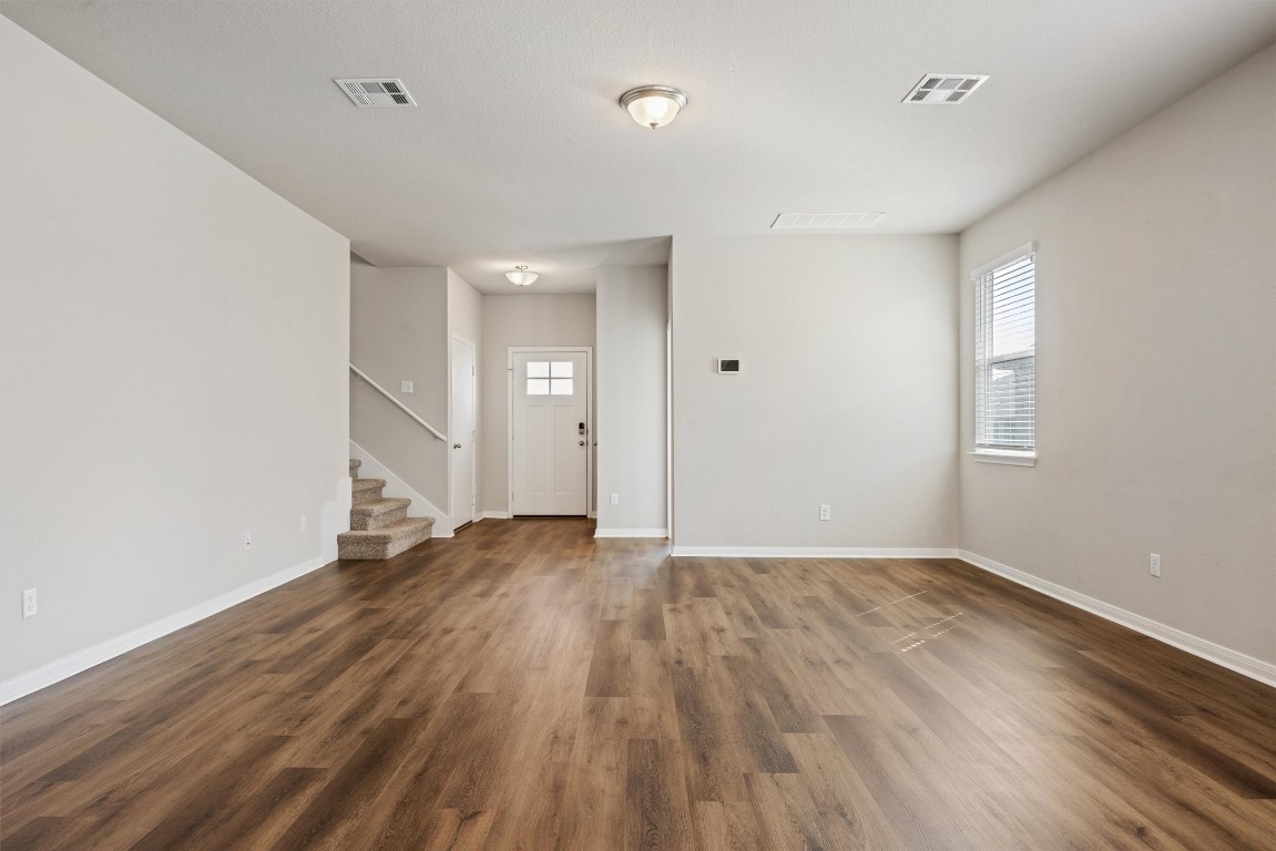 110 Lullaby Drive Georgetown, TX 78626 - Photo 3 of 39 an empty room with wooden floor and windows
