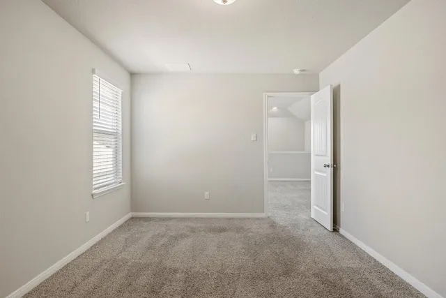 a view of an empty room with windows