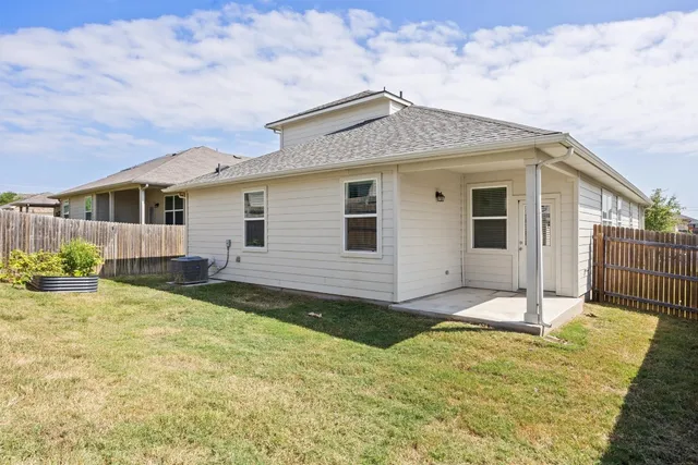 a view of a house with wooden fence