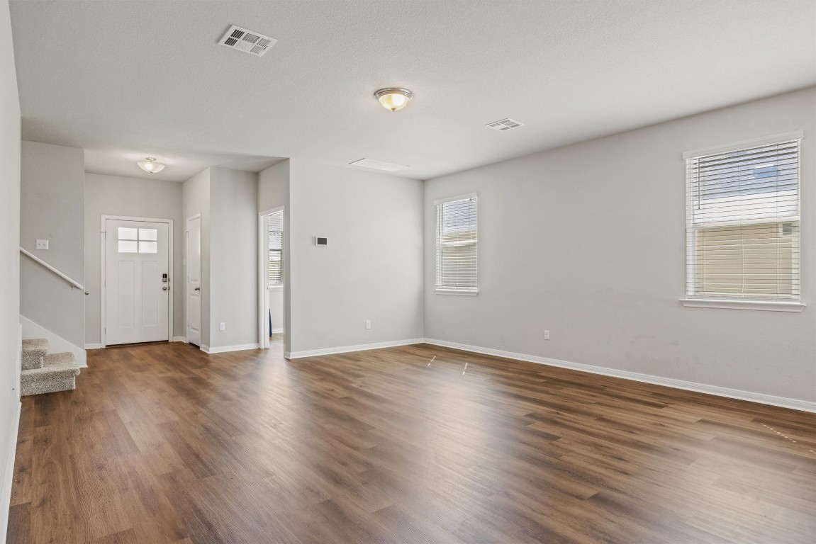 110 Lullaby Drive Georgetown, TX 78626 - Photo 4 of 39 an empty room with wooden floor and windows