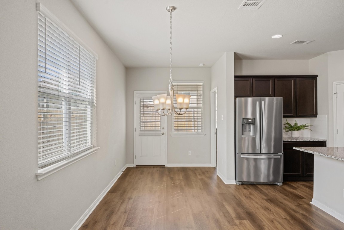 110 Lullaby Drive Georgetown, TX 78626 - Photo 6 of 39 a kitchen with stainless steel appliances a refrigerator and wooden floor