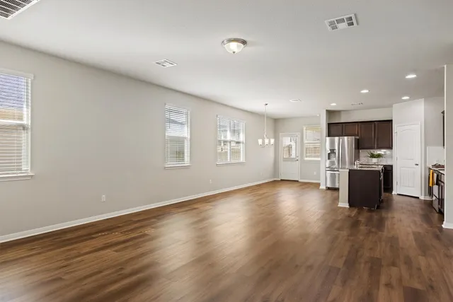 a view of kitchen with stainless steel appliances refrigerator microwave and stove