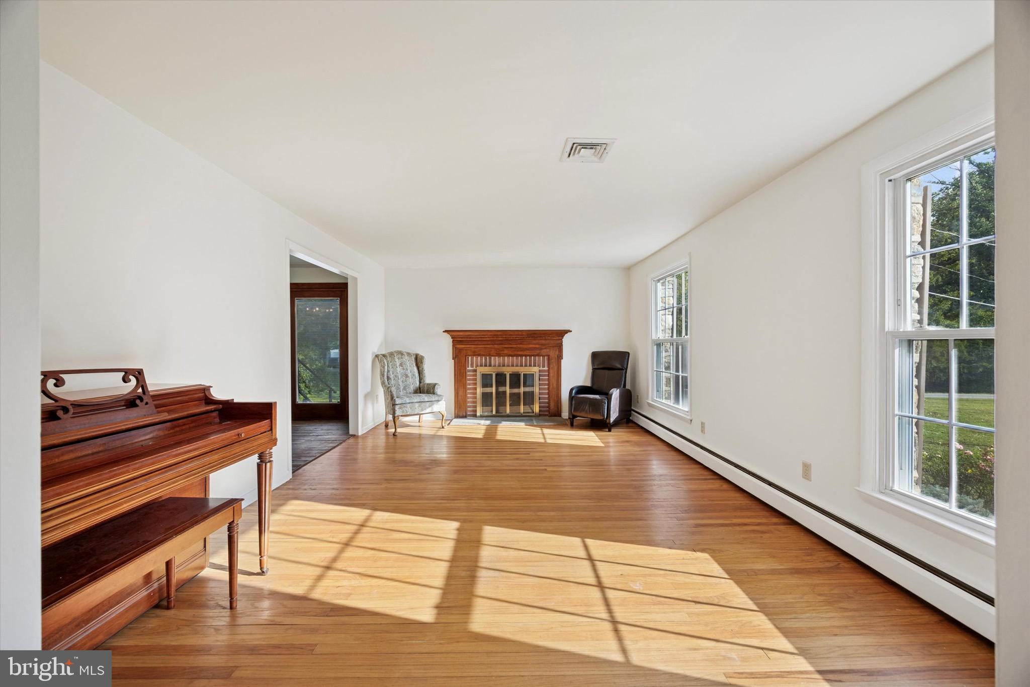 810 Harvey Road Wallingford, PA 19086 - Photo 4 of 32 a living room with furniture and a fireplace