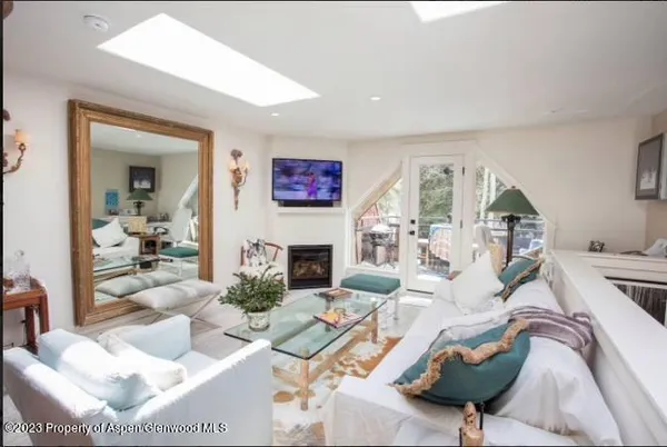 a living room with furniture a fireplace and a flat screen tv