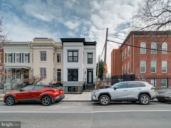 a car parked in front of a big house