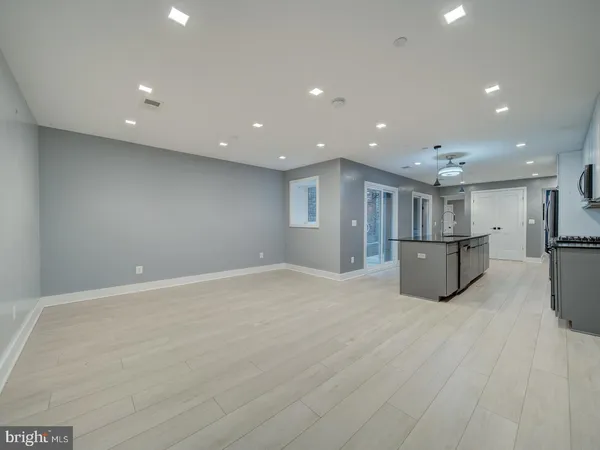 a view of kitchen with stainless steel appliances refrigerator oven and cabinets