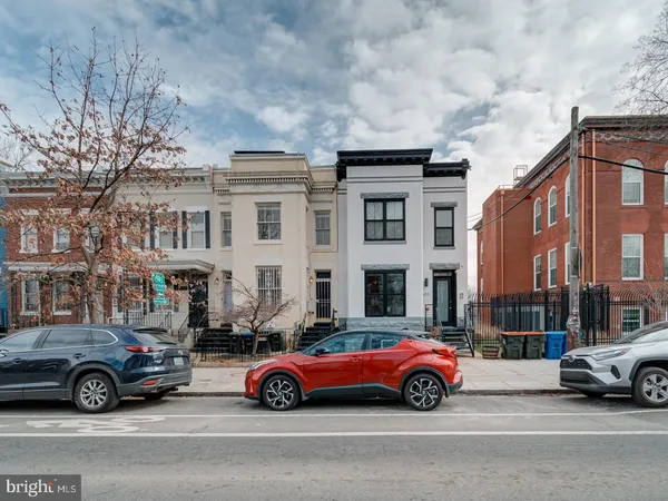 a car parked in front of a big house