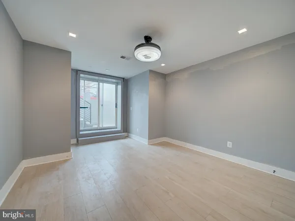 an empty room with windows and closet