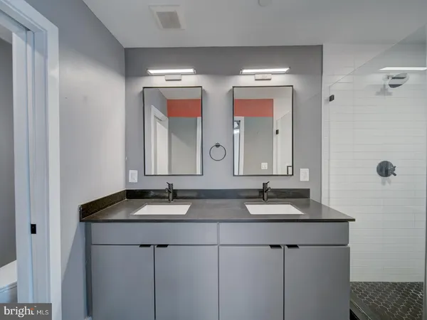 a bathroom with a sink vanity tub and a mirror