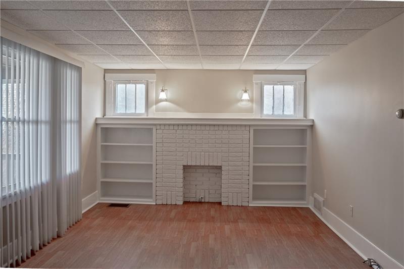 1404 Darlington Road Beaver Falls, PA 15010 - Photo 3 of 20 Large freshly painted living room with built in book cases for character along with plenty of sunlight!