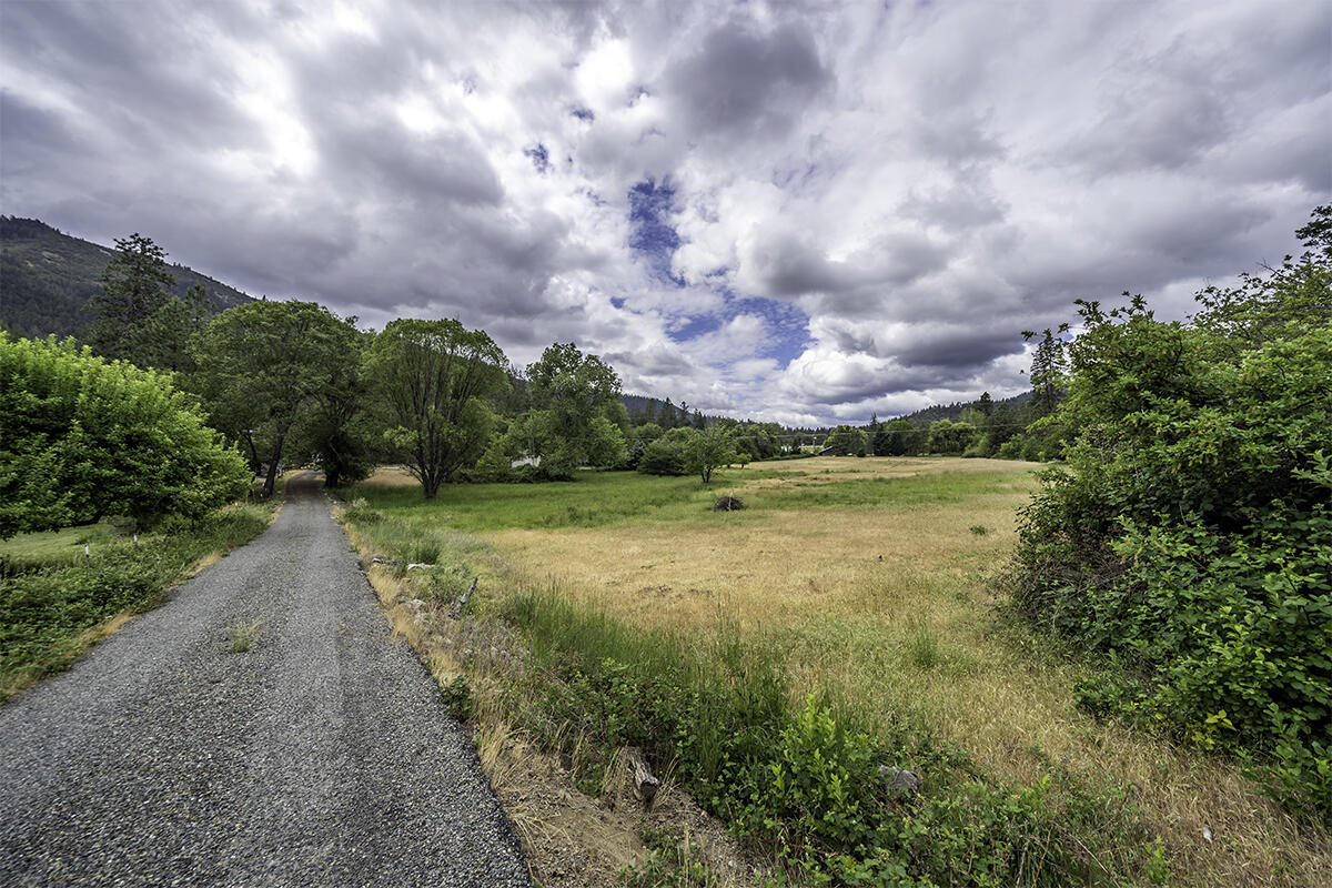 7255-7277 Upper Applegate Road Jacksonville, OR 97530 - Photo 34 of 36 a view of a lake with a big yard