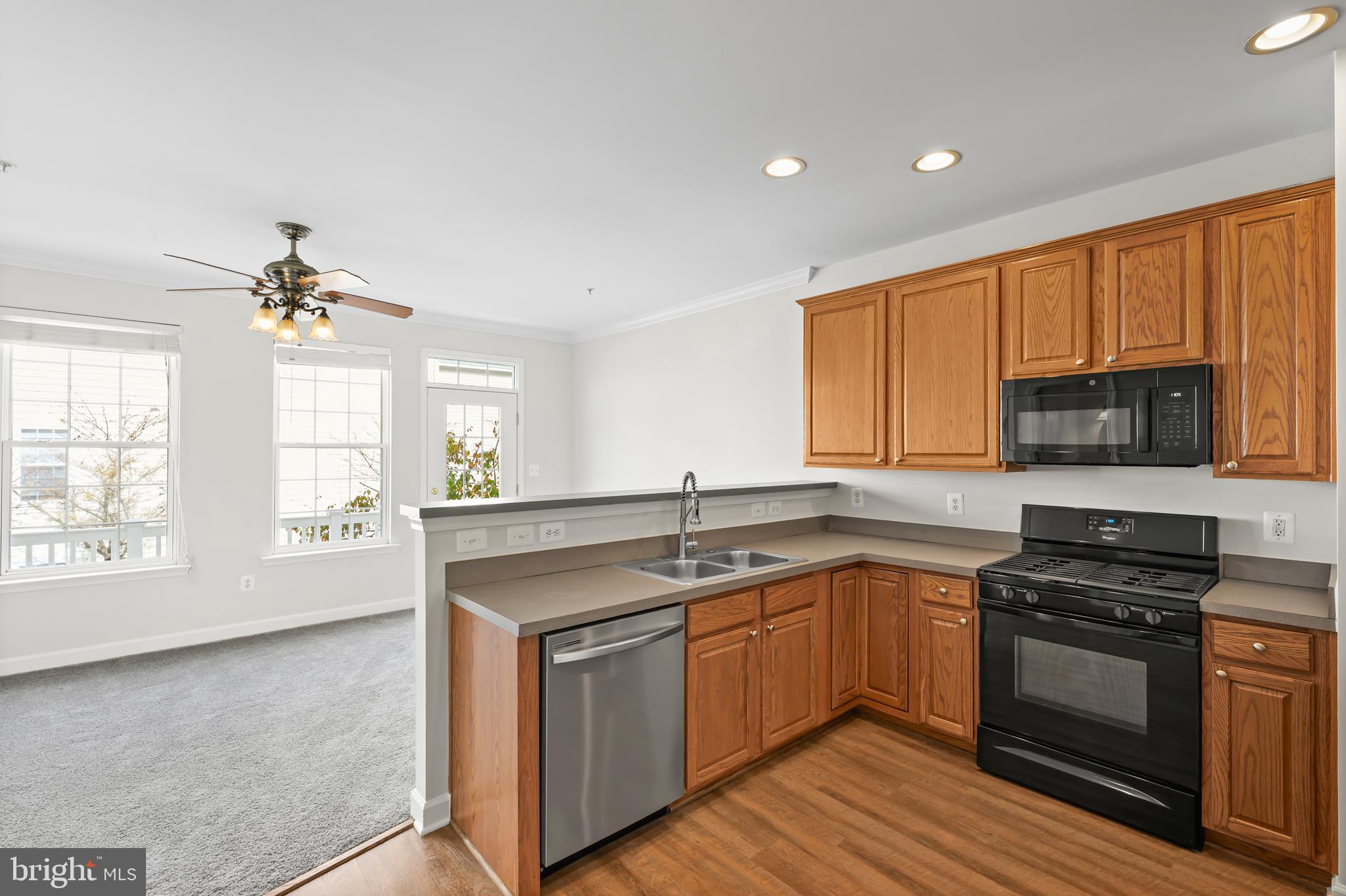 5564 Lanier Avenue Suitland, MD 20746 - Photo 11 of 37 a kitchen with stainless steel appliances granite countertop a sink stove and microwave
