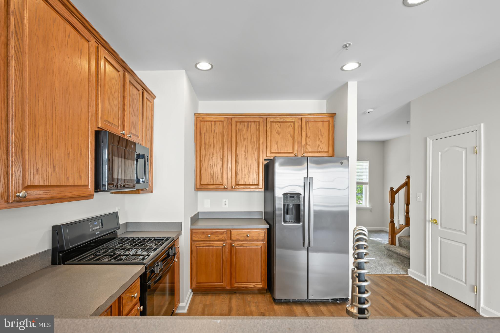 5564 Lanier Avenue Suitland, MD 20746 - Photo 13 of 37 a kitchen with stainless steel appliances granite countertop a refrigerator and a stove