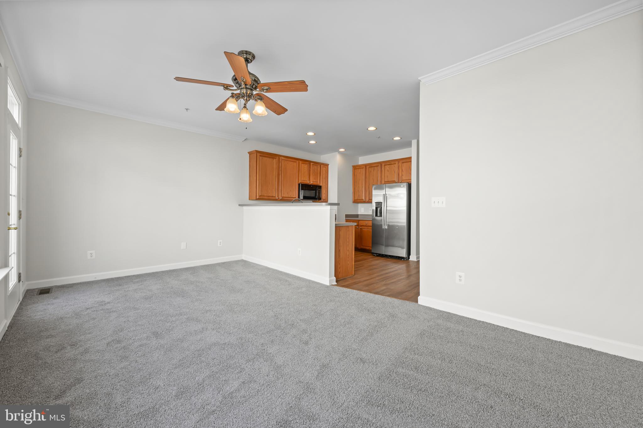 5564 Lanier Avenue Suitland, MD 20746 - Photo 17 of 37 a view of a livingroom with a ceiling fan and kitchen view