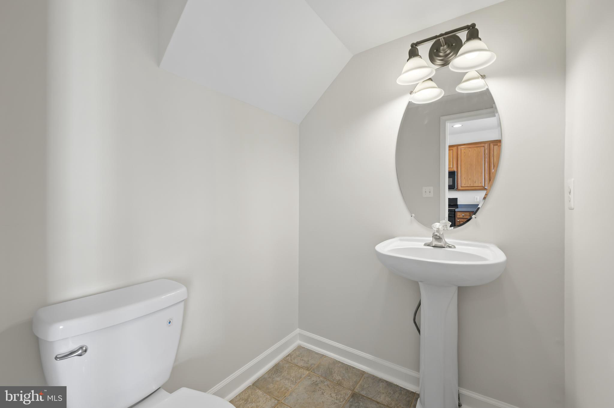5564 Lanier Avenue Suitland, MD 20746 - Photo 18 of 37 a bathroom with a toilet sink and mirror