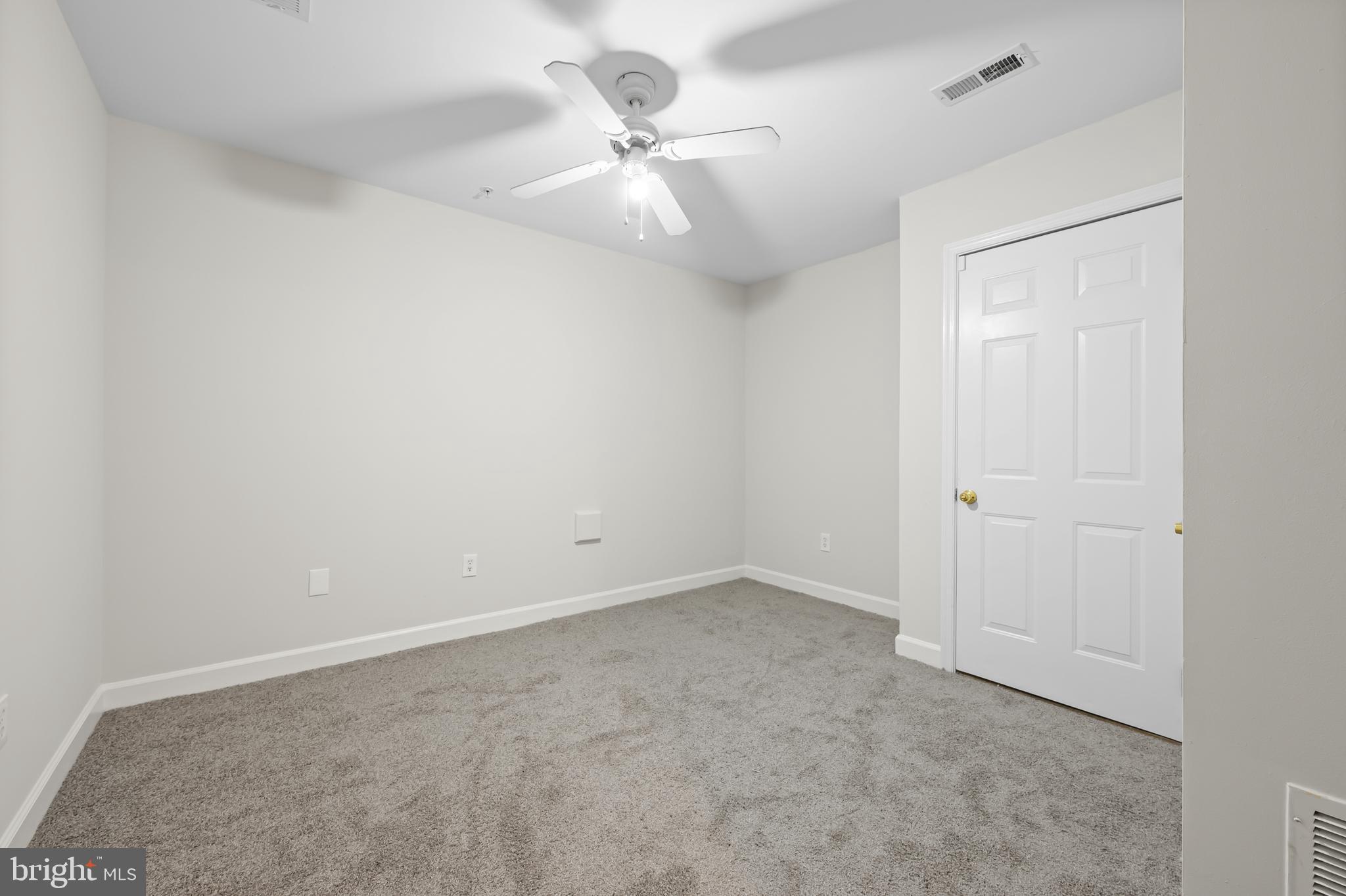 5564 Lanier Avenue Suitland, MD 20746 - Photo 29 of 37 an empty room with a ceiling fan and a window