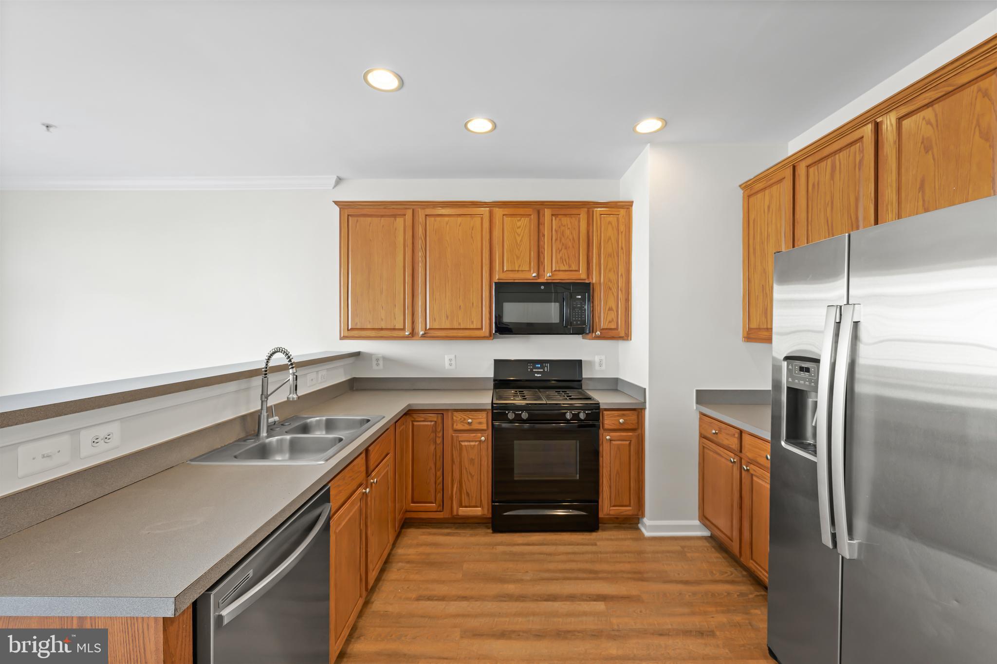 5564 Lanier Avenue Suitland, MD 20746 - Photo 3 of 37 a kitchen with stainless steel appliances granite countertop a sink stove and refrigerator
