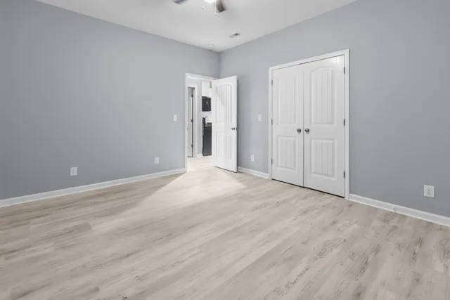 a view of an empty room and wooden floor