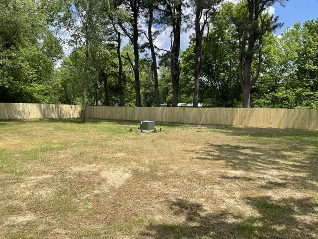 a view of a swimming pool and a yard