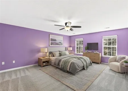 a spacious bedroom with a bed and a couch