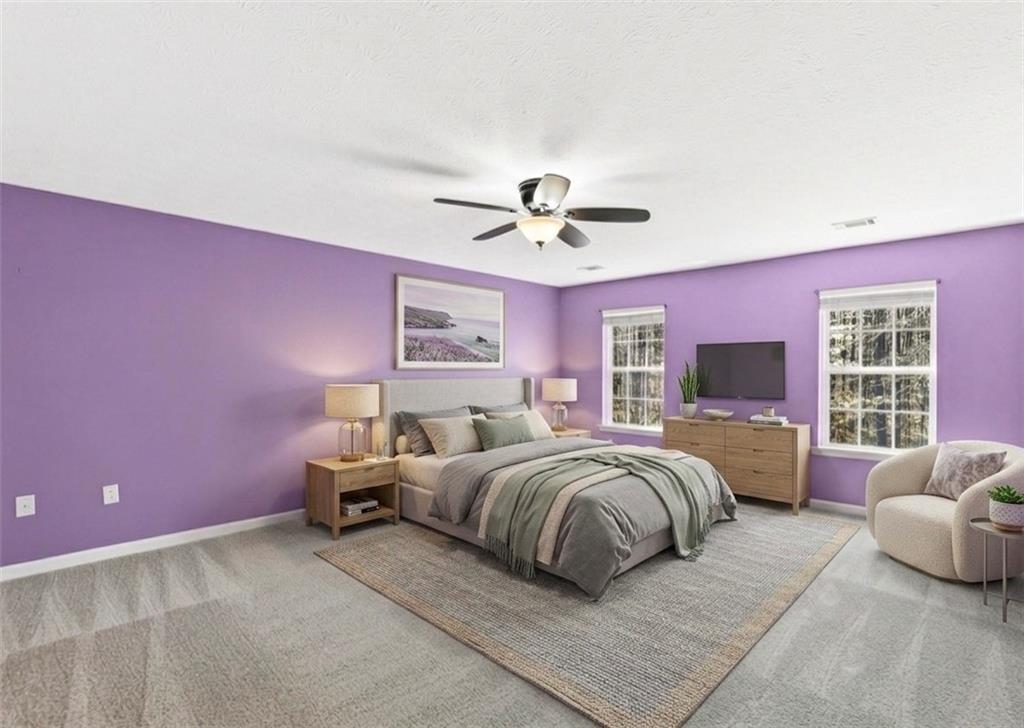 5976 Bowers Road Stone Mountain, GA 30087 - Photo 12 of 31 a spacious bedroom with a bed and a couch