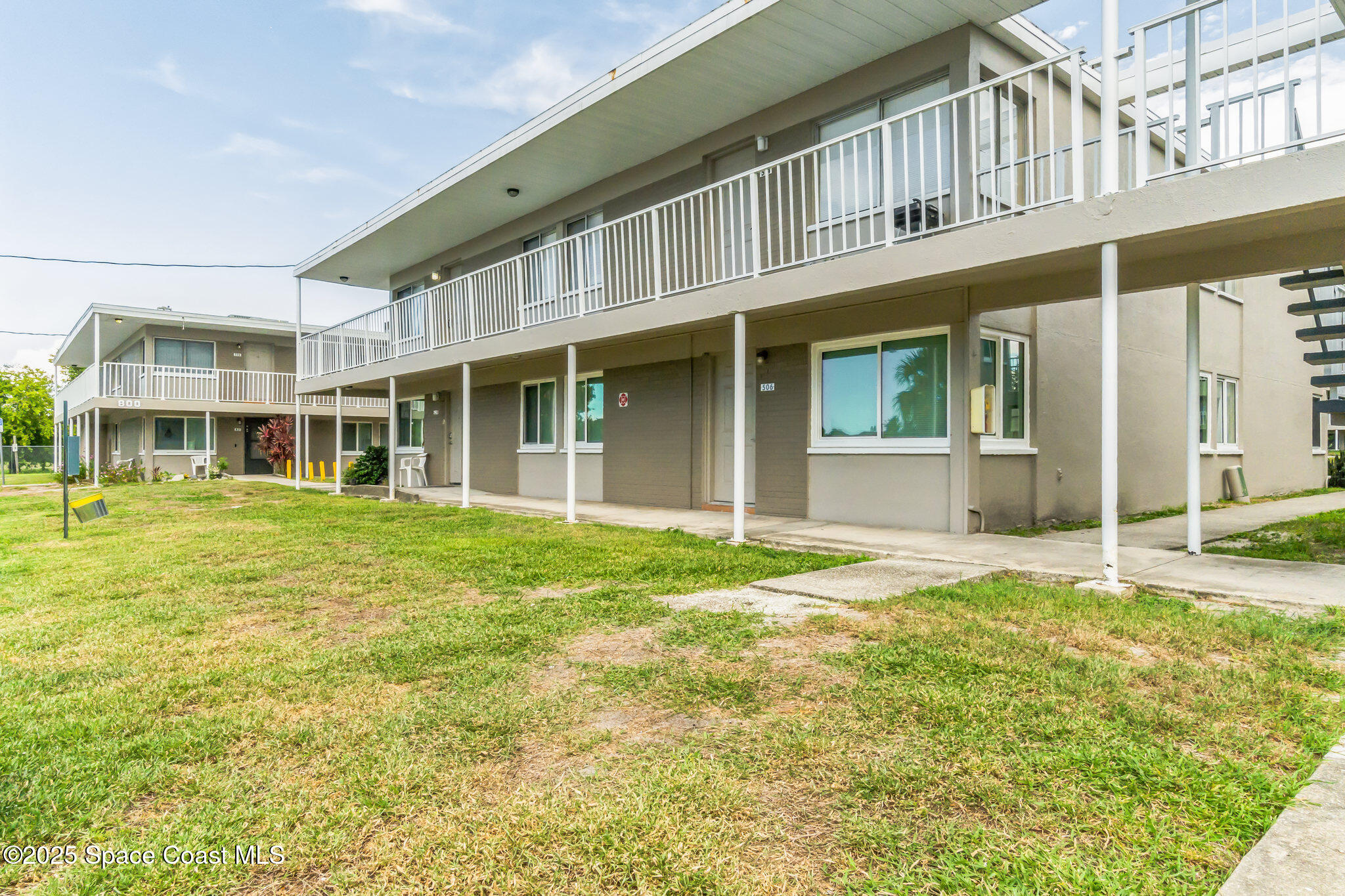 front view of a brick house with a yard