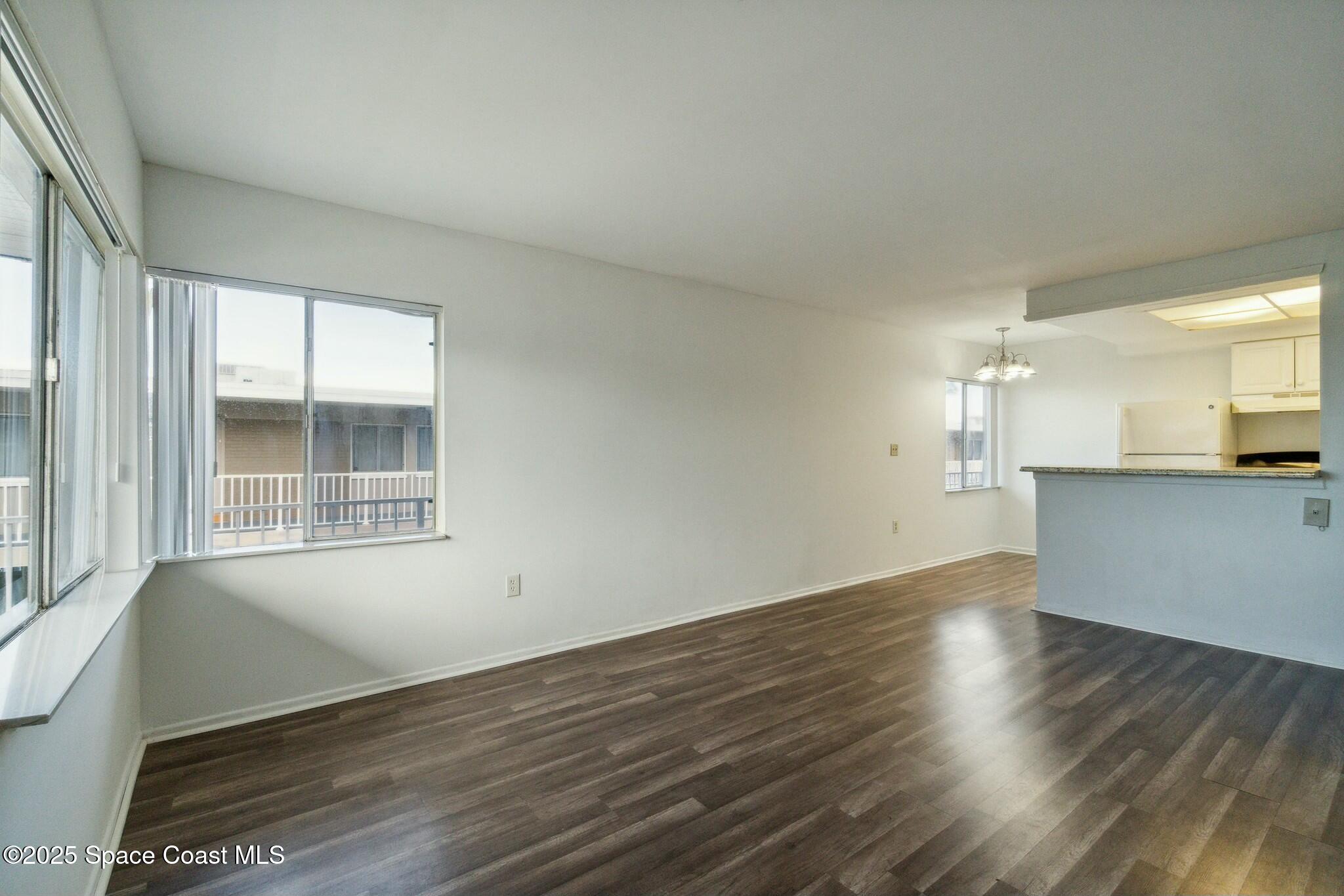 800 North Fiske Boulevard, Unit 513 Cocoa, FL 32922 - Photo 14 of 21 a view of an empty room with wooden floor and a window