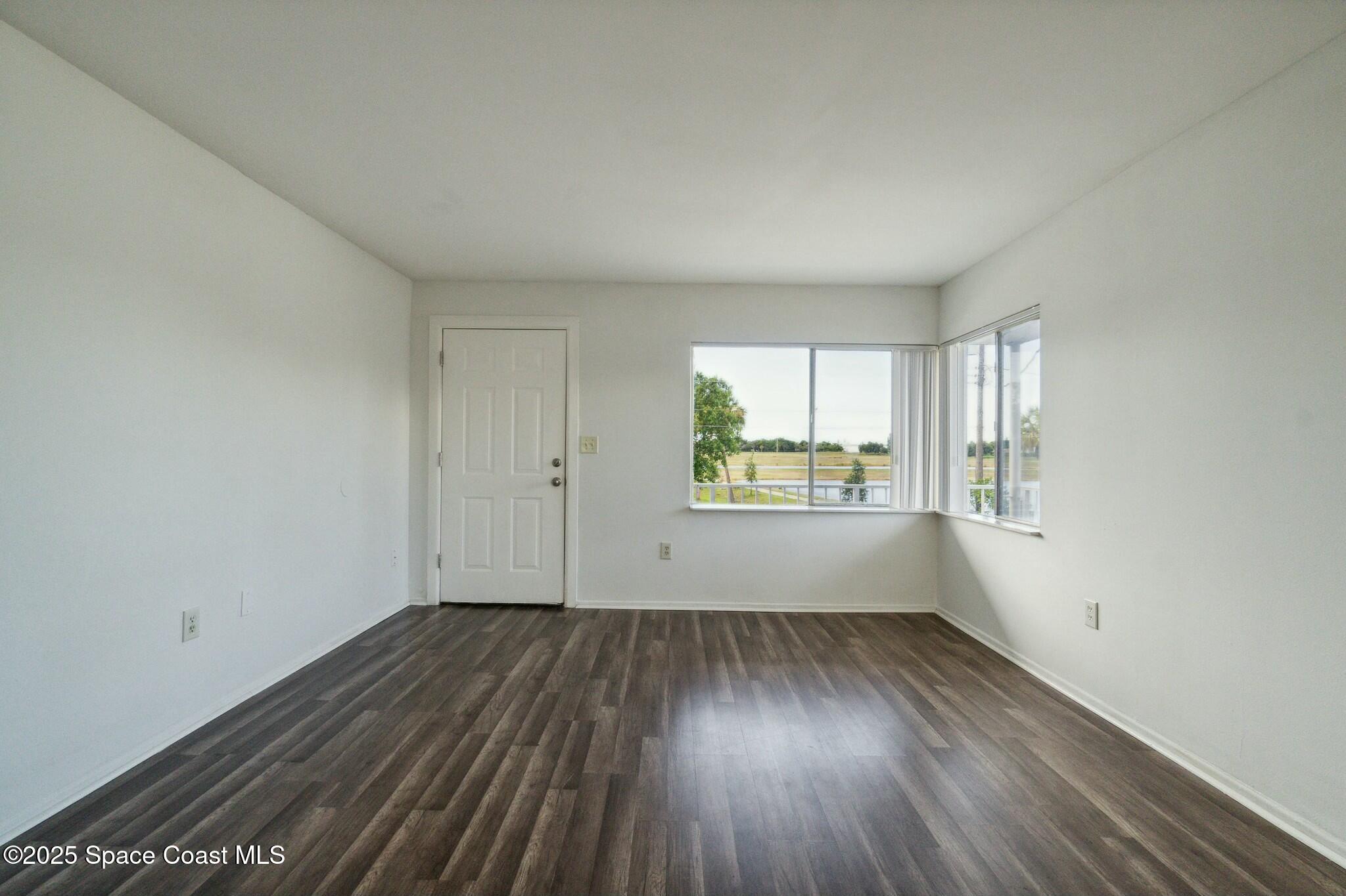 800 North Fiske Boulevard, Unit 513 Cocoa, FL 32922 - Photo 16 of 21 wooden floor in an empty room with a window
