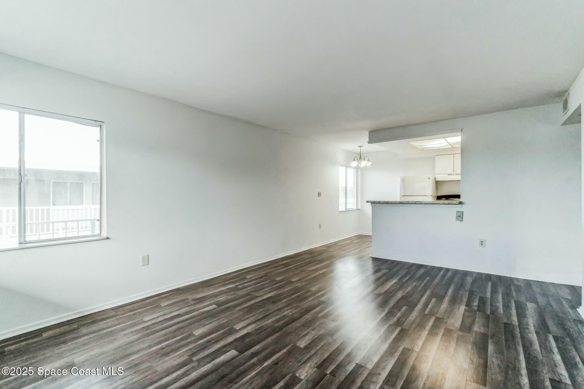 800 North Fiske Boulevard, Unit 513 Cocoa, FL 32922 - Photo 17 of 21 wooden floor in an empty room with a window