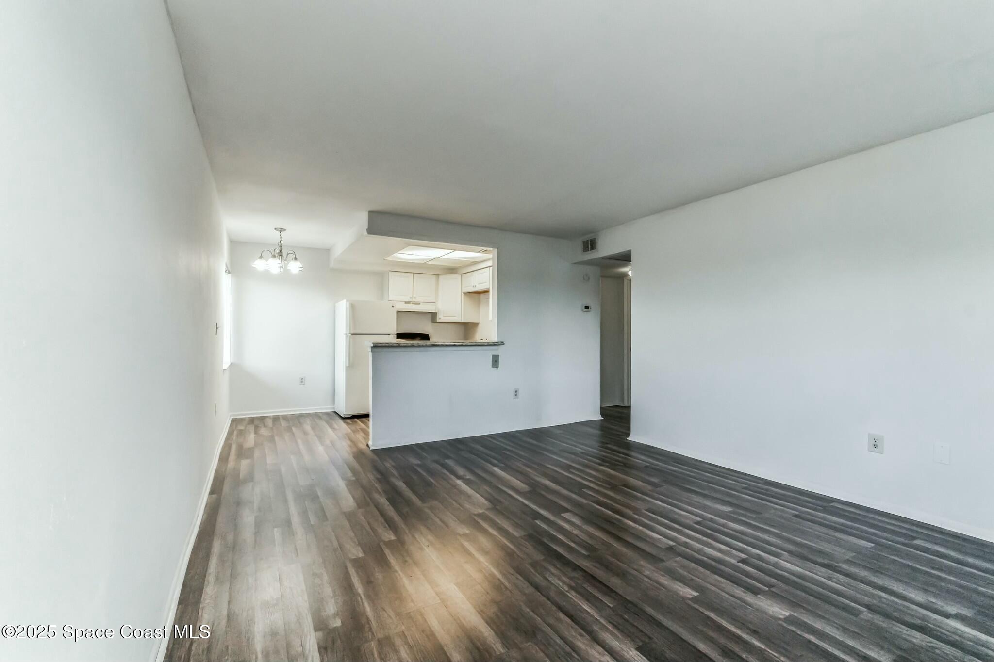 800 North Fiske Boulevard, Unit 513 Cocoa, FL 32922 - Photo 18 of 21 a view of a kitchen with wooden floor and a sink