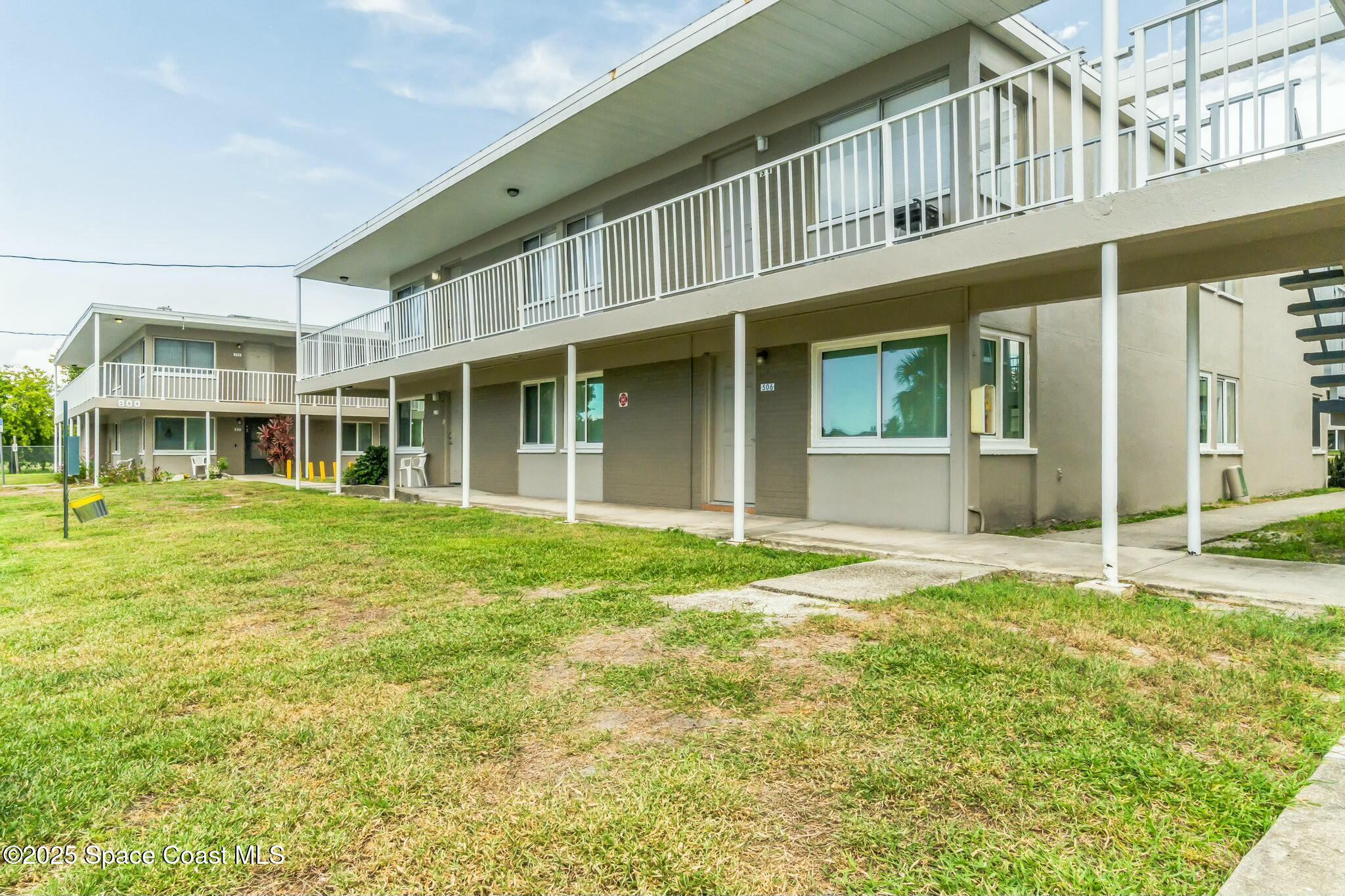800 North Fiske Boulevard, Unit 513 Cocoa, FL 32922 - Photo 2 of 21 front view of a brick house with a yard