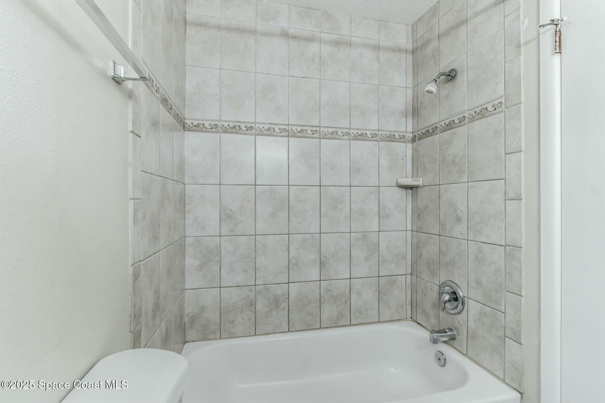 800 North Fiske Boulevard, Unit 513 Cocoa, FL 32922 - Photo 6 of 21 a bathroom with a bathtub and shower
