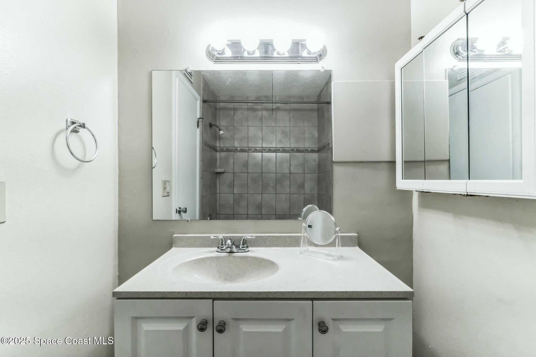 800 North Fiske Boulevard, Unit 513 Cocoa, FL 32922 - Photo 7 of 21 a bathroom with a sink and a mirror