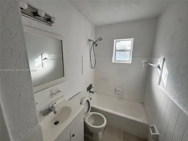 a bathroom with a bathtub toilet and a sink