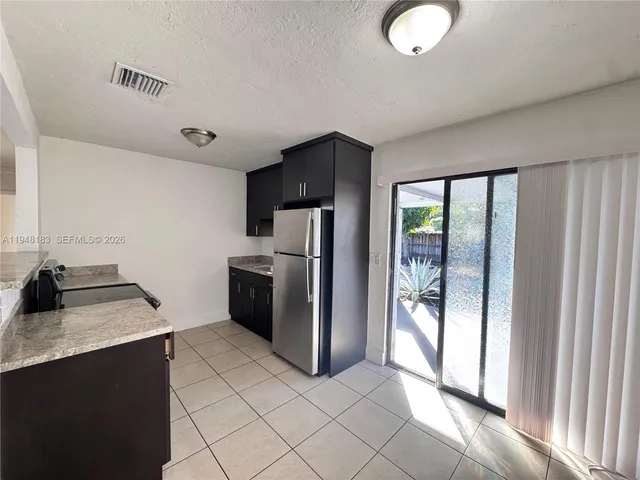 a kitchen with stainless steel appliances a refrigerator and a sink