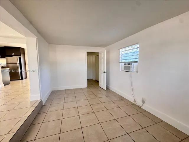 a view of an empty room and bathroom