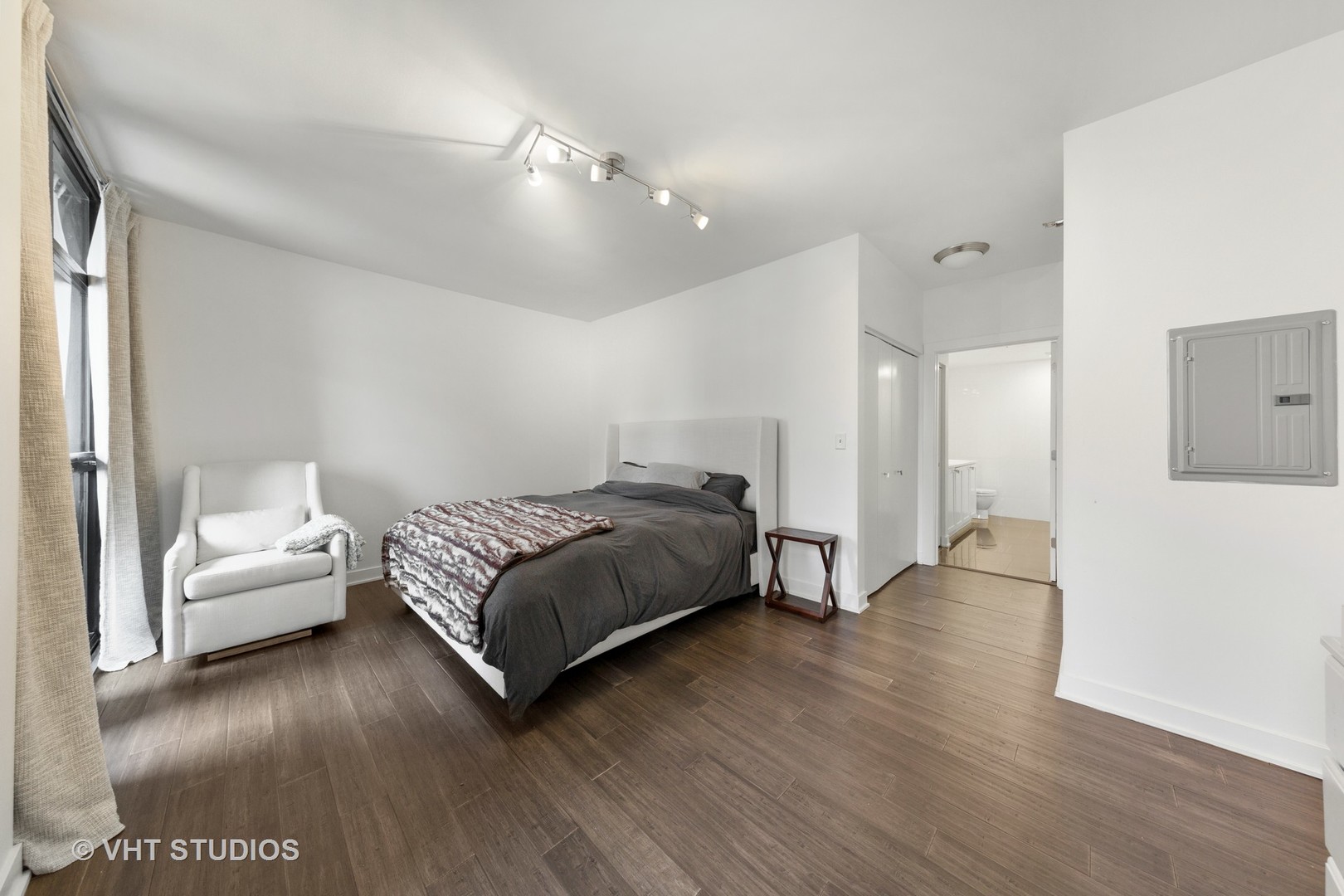 1255 South State Street, Unit 1603 Chicago, IL 60605 - Photo 13 of 21 a spacious bedroom with a bed and a couch