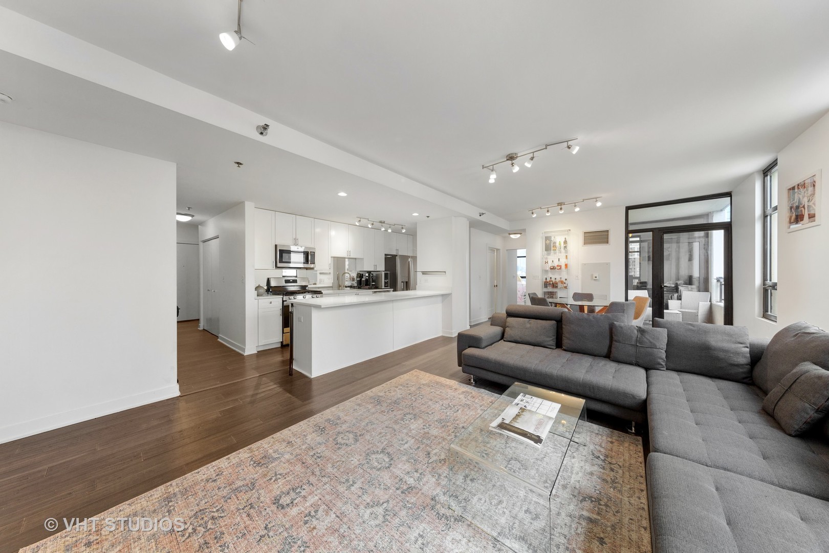 1255 South State Street, Unit 1603 Chicago, IL 60605 - Photo 5 of 21 a living room with furniture and view of kitchen