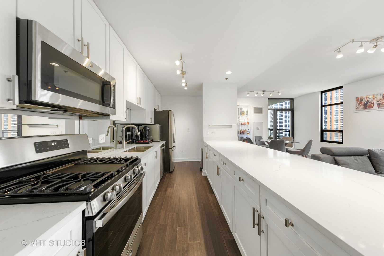 1255 South State Street, Unit 1603 Chicago, IL 60605 - Photo 7 of 21 a large white kitchen with stainless steel appliances