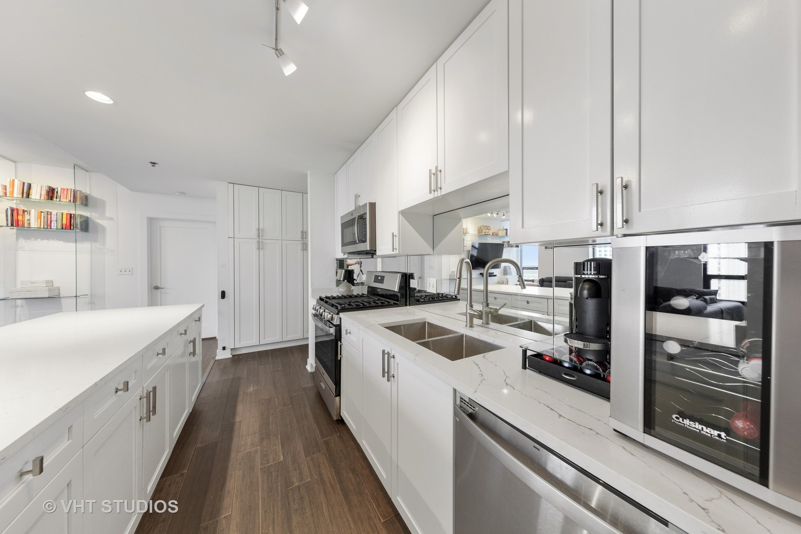 1255 South State Street, Unit 1603 Chicago, IL 60605 - Photo 9 of 21 a kitchen with a sink a counter top space stainless steel appliances and cabinets