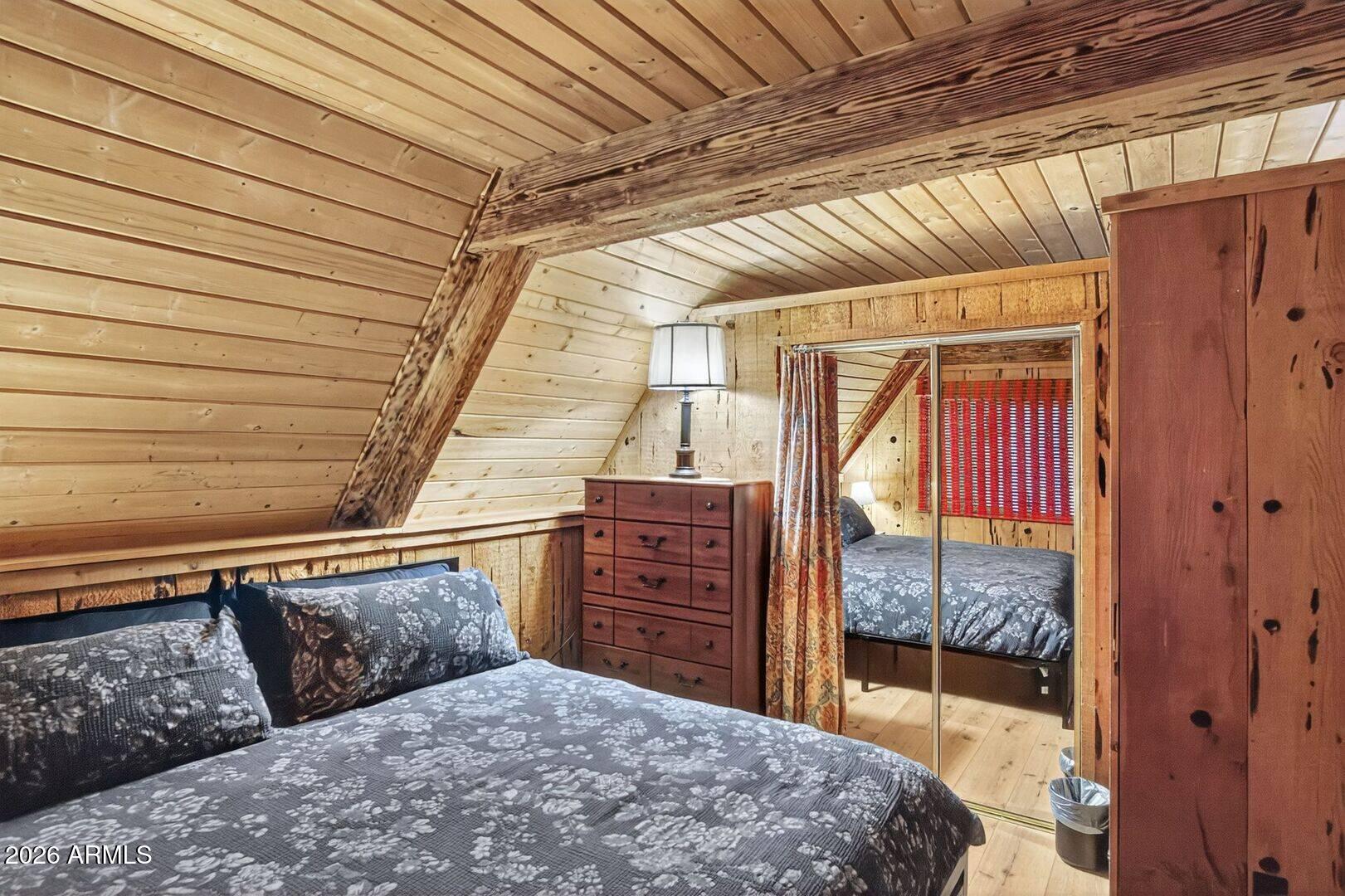 8884 Tonto Rim Drive Pine, AZ 85544 - Photo 34 of 43 a bedroom with a bed and wooden floor