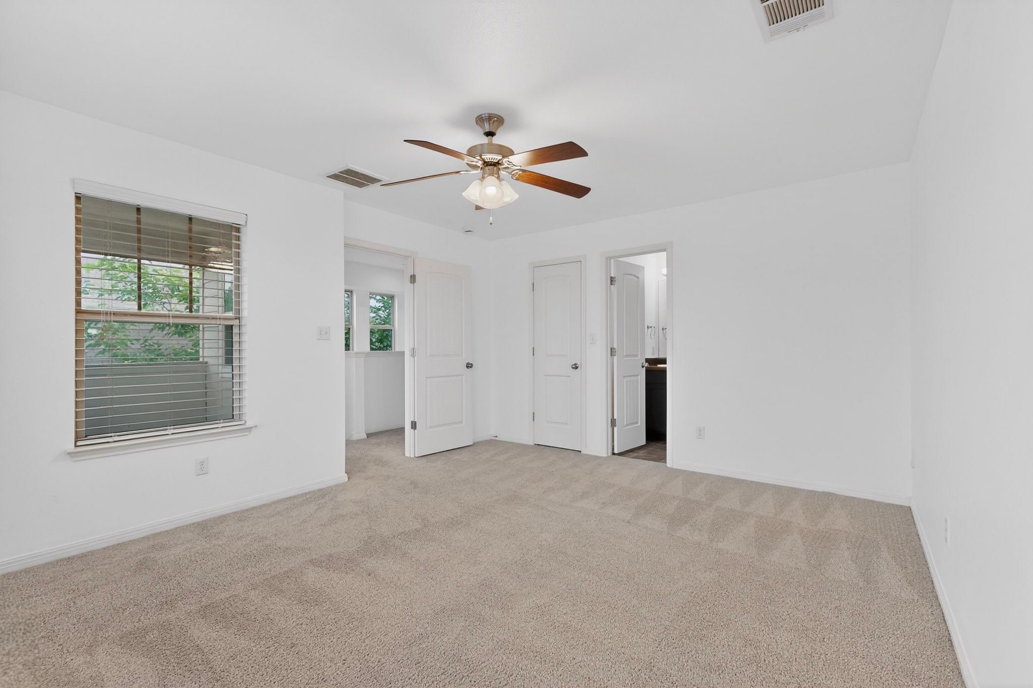 4619 Inicio Lane Austin, TX 78725 - Photo 18 of 32 an empty room with chandelier fan and windows
