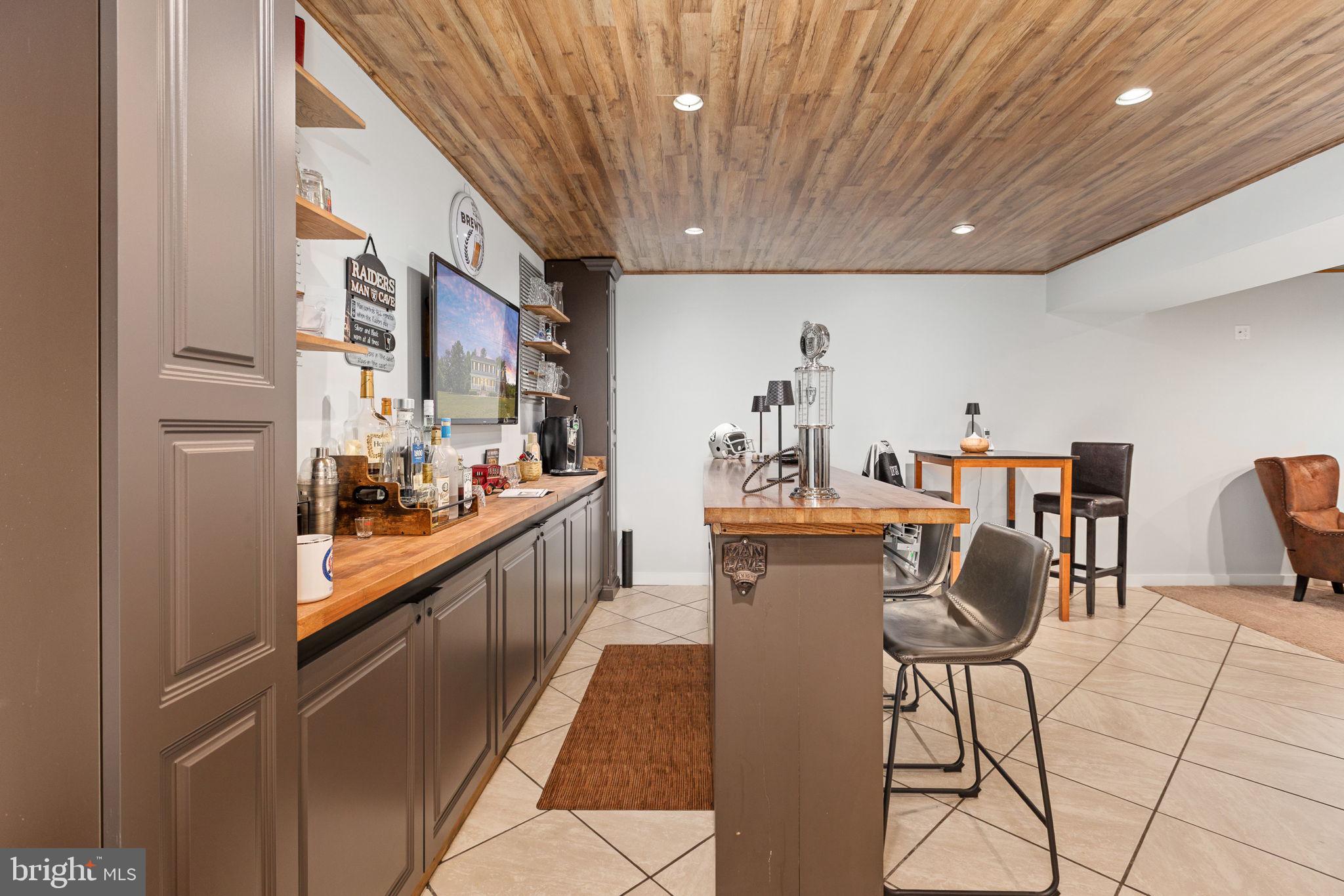 22088 Landora Bridge Road Ruther Glen, VA 22546 - Photo 74 of 122 Stylish home bar with rustic charm.