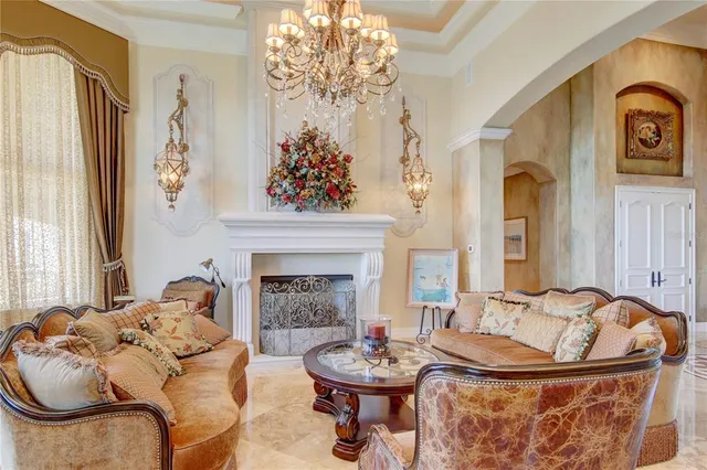 a living room with furniture a flat screen tv and floor to ceiling window