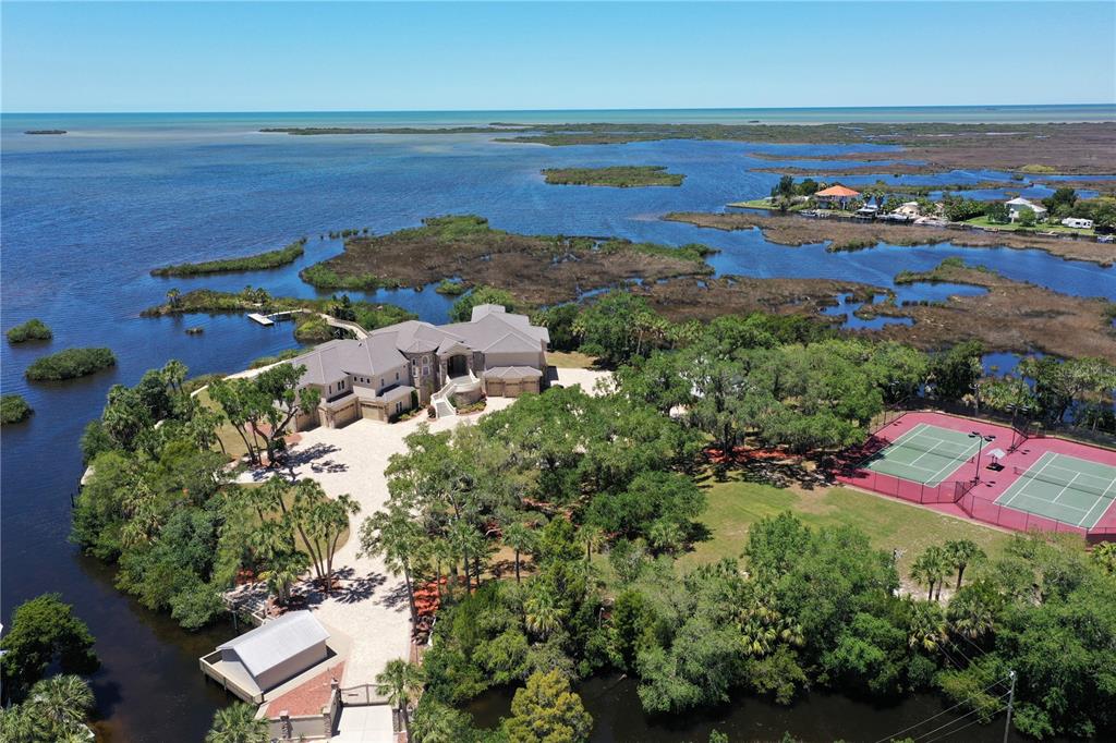 1227 Osowaw Boulevard Spring Hill, FL 34607 - Photo 3 of 96 an aerial view of lake residential house with outdoor space
